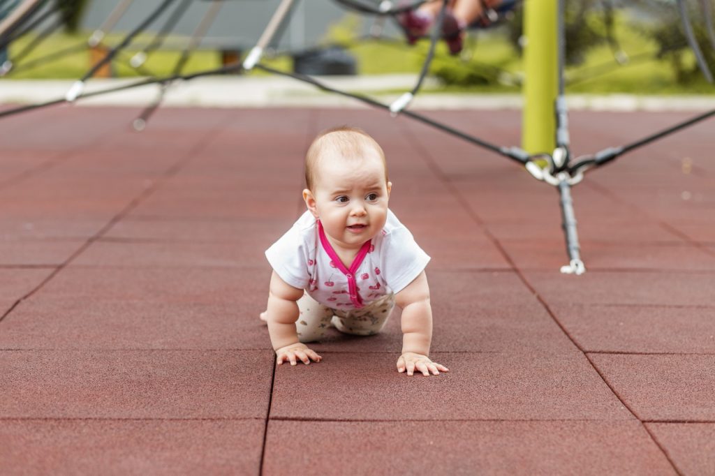 Baby Crawling on Playground Rubber Floor;